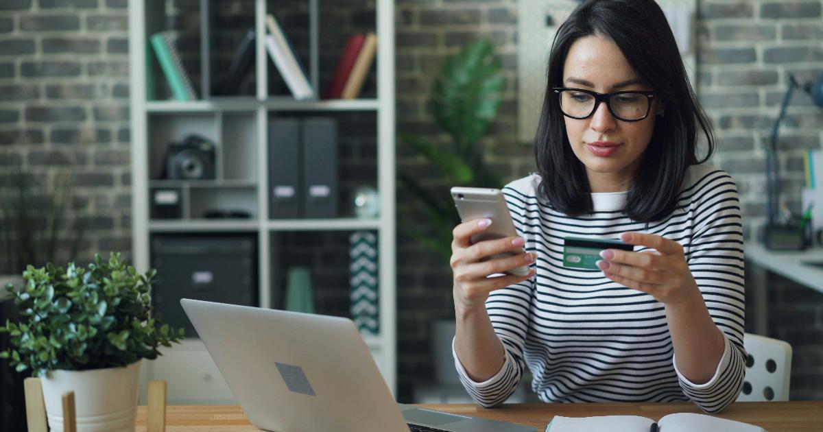 A person reviewing a credit score on a laptop with a notebook, illustrating key credit scores terms in plain language