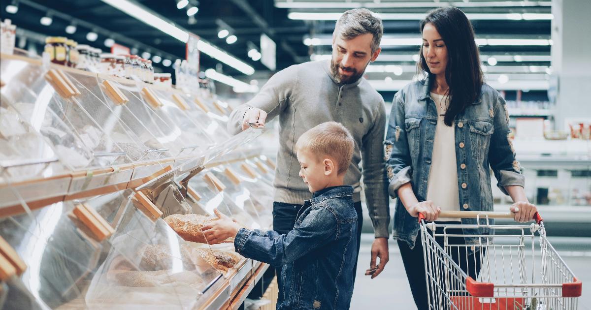 A family reviewing grocery receipts and a budget notebook to practice calm budgeting for grocery overspending
