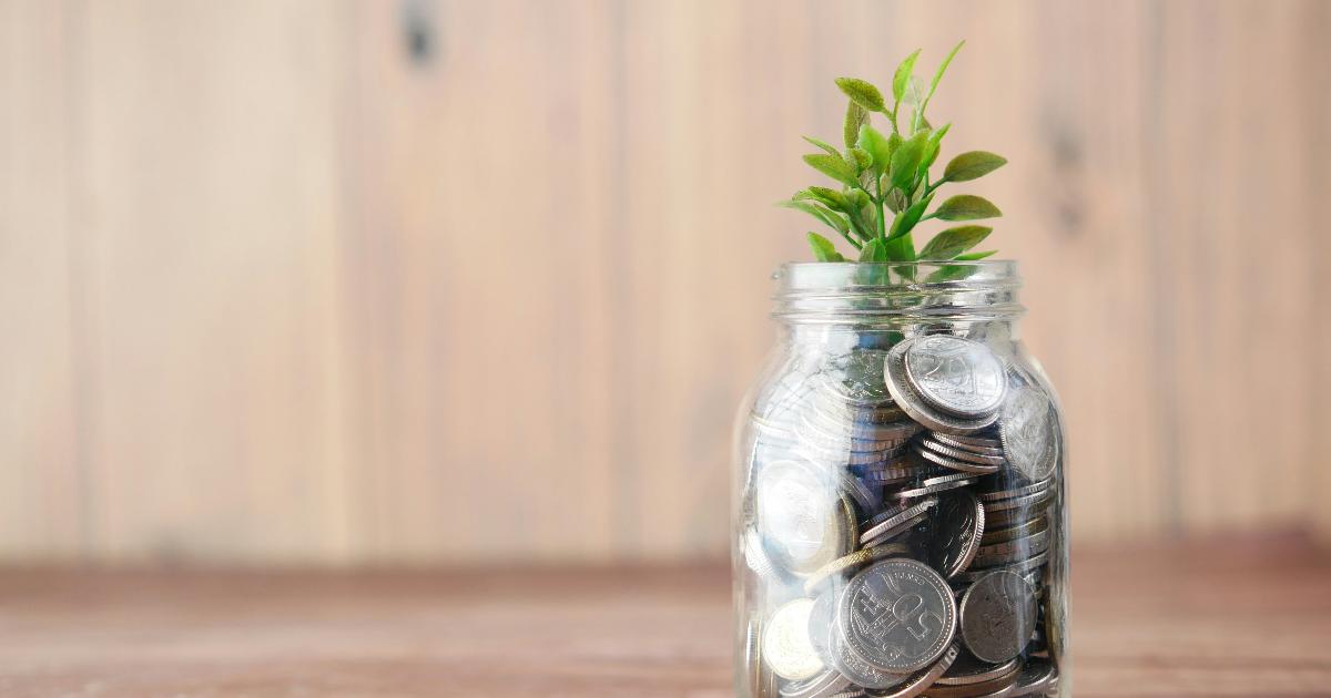 A person organizing savings jars and a notebook, illustrating an emergency fund as a cushion you control