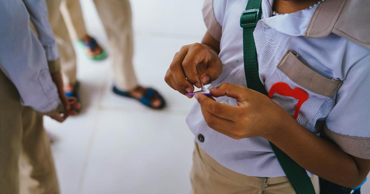 Parents comparing school uniforms and prices to make the most of the new school uniform rules and save money