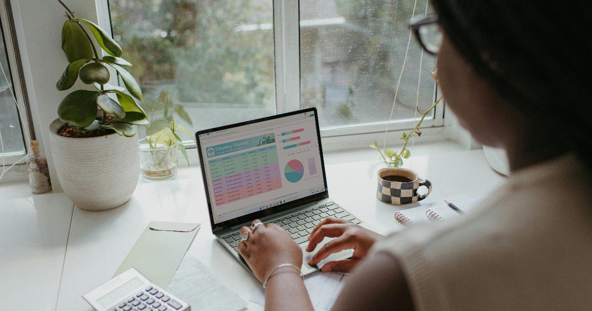 Person reviewing monthly bills and subscriptions to identify forgotten recurring expenses they can cut from their budget