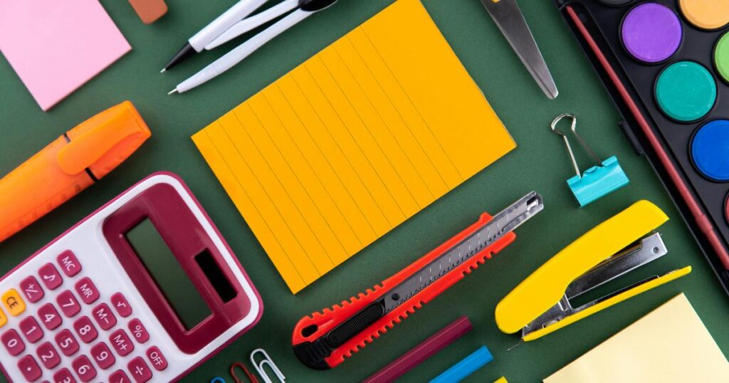 A calm back-to-school budget setup with school supplies, a backpack, and a checklist on a kitchen table