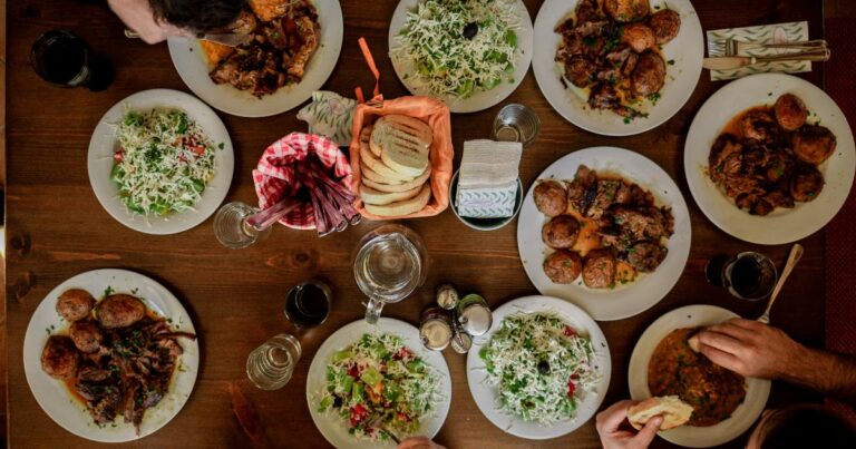 A Thanksgiving dinner table with roasted chicken, stuffing, and pumpkin cake, showing holiday budgeting through smart planning