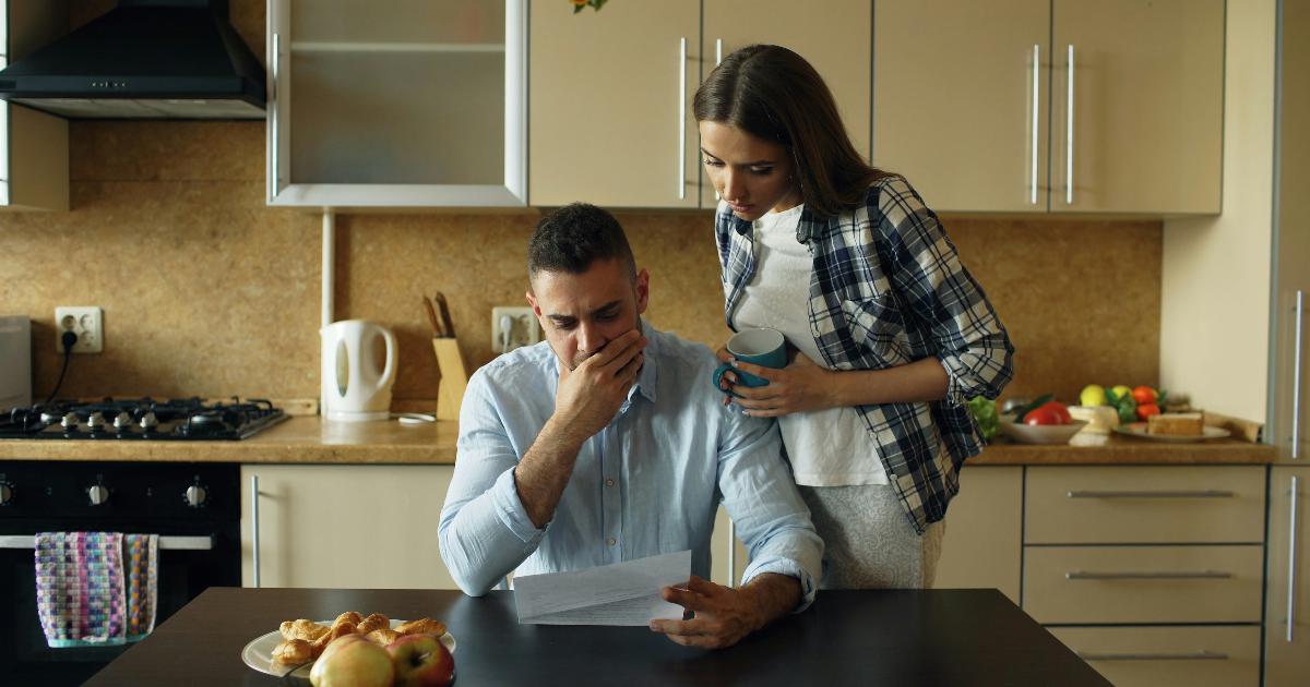 A couple reviewing a budget and pension statement, illustrating early retirement savings levers